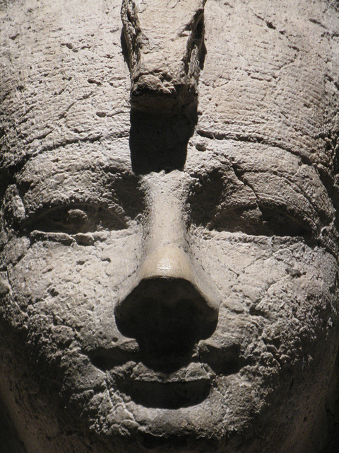 Ancient stone sculpture of a pharaoh's face.