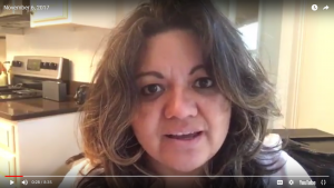Person speaking in a kitchen setting.