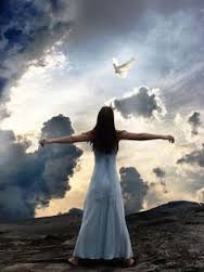 Woman with open arms under cloudy sky.