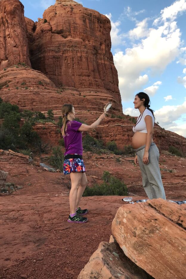 Two women in a red rock landscape.